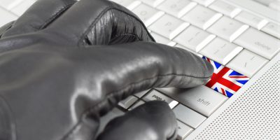 Hacking,Uk,Concept,With,Hand,Wearing,Black,Leather,Glove,Pressing